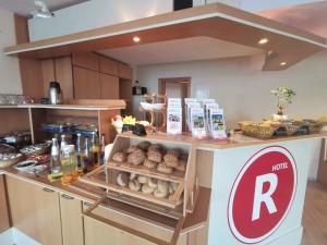 a kitchen with a counter with food on it at REGIOHOTEL Salzland Schönebeck 