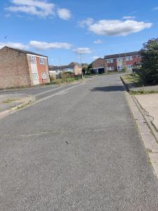 an empty street with buildings in the background at Spacious Comfortable 4 Bedroom House in Aylesbury +9 photos