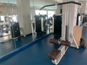 a gym with a row of treadmills and mirrors at Arcadia beach 网红水系公寓一房 Nice view 专业的健身房 桑拿 中心位置 交通便利 Smart tv WiFi in Pattaya South