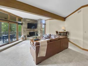 a large living room with a brown leather couch at 24B Powder Run condo in Park City