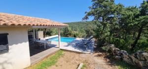 a house with a deck and a swimming pool at Villa Giulia in Porto-Vecchio