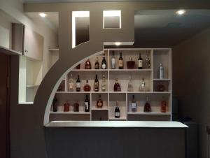 a room with a shelf with bottles of alcohol at Forest Guest House in Alaverdi