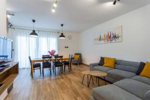 a living room with a couch and a table at Modern holiday house near beach in Fažana