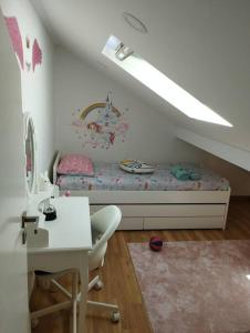 a bedroom with a bed and a desk and a table at Katyto house in Costa da Caparica