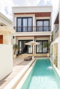 eine Villa mit Swimmingpool und ein Haus in der Unterkunft Ramana Villa Uluwatu in Uluwatu