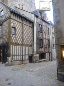 an old building with a sign in front of it at Le Nid De La Loire in Blois