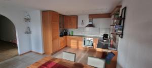 a kitchen with wooden cabinets and a stove top oven at Ruheort in Beinwil