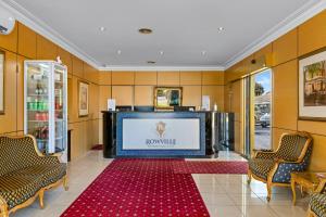 a lobby with a large screen in a building at Rowville International Hotel in Rowville