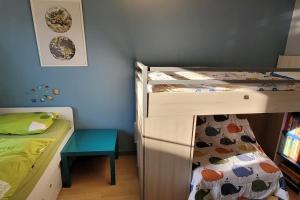 a bedroom with two bunk beds and a table at family house, free parking, 15min. walk to city in Bruges