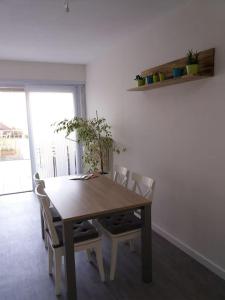 a wooden table and chairs in a room at family house, free parking, 15min. walk to city in Bruges