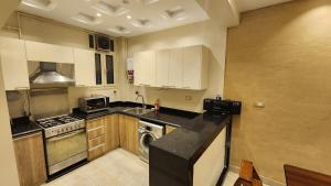 a kitchen with a stove and a dishwasher in it at Azarita luxury apartment - families only in Alexandria