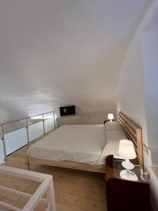 a bedroom with a bed and a desk and a tv at Casina dei Fiori in Molfetta