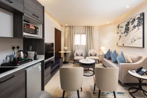 a living room with a couch and a table at Merya Hotel Apartment - Zahra in Jeddah
