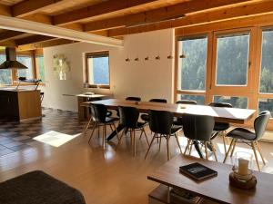 a large dining room with a table and chairs at La Trapla in Samnaun