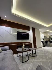 a living room with a couch and a table at Self check in Unique 3 Bedrooms Apartment in Riyadh