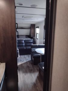 a living room with couches and a table in a room at Branson RV Park in Branson