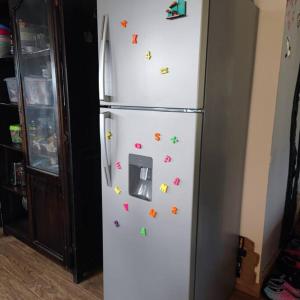 a refrigerator with magnets on the side of it at Casa con Piscina en Nanegalito in La Delicia