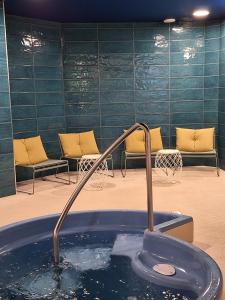 a hot tub with a faucet in a room at Majvik Congress Hotel in Kirkkonummi