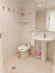 a white bathroom with a sink and a toilet at Benidorm Carolina Beach & Pool in Benidorm