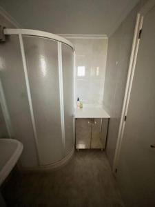 a small bathroom with a shower and a sink at Benidorm Carolina Beach & Pool in Benidorm