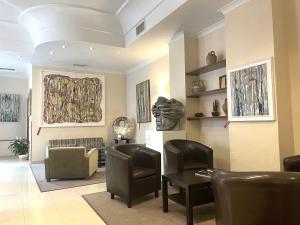 a living room with a couch and a table and chairs at Hotel Nuvò in Naples