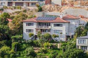 a house with solar panels on its roof at Glenview Heads Apartments in Knysna