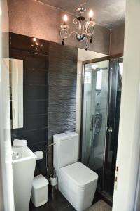 a bathroom with a toilet and a glass shower at Sunlight Residence in Kalo Chorio