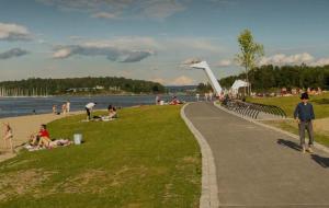 a group of people sitting on the grass at a beach at Rose in Sandvika