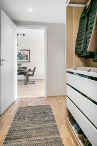 a hallway with a dining room and a dining table at Rose in Sandvika