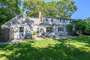 a house with a large yard with a deck at 55 Wianno Circle Osterville - O Captain My Captain in Osterville