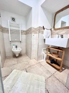 a bathroom with a sink and a mirror at DIMORA ELIVA in Monopoli +27 photos