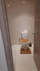 a bathroom with a toilet with a wooden seat at Appartement meublé in Agadir