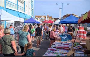 a crowd of people walking around a farmers market at Mobilhome P27 6 personnes climatisé in Le Portel