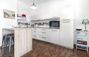 a white kitchen with white cabinets and a counter at Abby in Dramalj