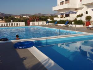 a swimming pool in front of a building at Villas Michalis in Chorafakia