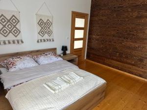 a bedroom with a bed with two pillows on it at Apartament D&D in Gorlice
