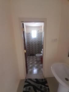 a bathroom with a toilet and a sink at seville suites in Eldoret