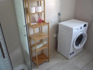 a bathroom with a washing machine and a washer at Casa di Giò in Pettenasco