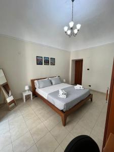 a bedroom with a large bed and a chandelier at Al Centro Storico in Catania