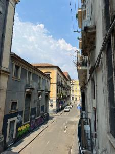an empty city street with buildings on either side at Al Centro Storico in Catania