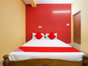 a red bedroom with a bed with red walls at Hotel O Lakshmi Sri Boarding & Lodging in Bengaluru +60 photos