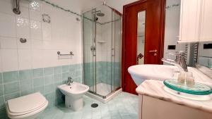 a bathroom with a toilet and a sink and a shower at B&B Villa Irma in Sorrento
