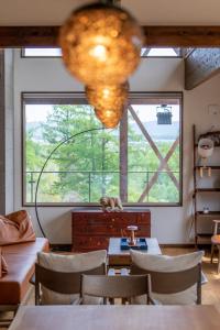 a room with tables and chairs and a large window at SANGA HOUSE in Kutchan