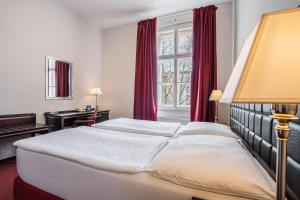 Rúm í herbergi á EA Hotel Tosca