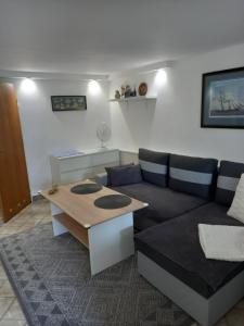 a living room with a couch and a table at Apartment with garden access in Szczecin