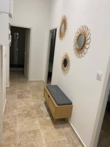 a room with a bench and two mirrors on the wall at Superbe appartement à 5 minutes à pied de la mer in Toulon