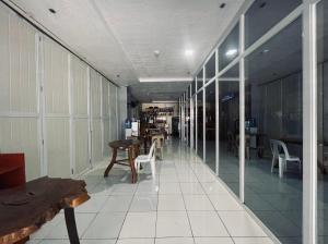 a hallway with tables and chairs in a building at A and A Bed and Breakfast Inn powered by Cocotel in Legazpi