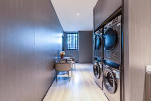a laundry room with a washer and dryer at Gongxili - Xige Hotel in Chengdu