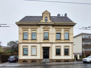 a yellow building with a tower on top of it at Die ideale Wohnung für 2 Personen in Solingen