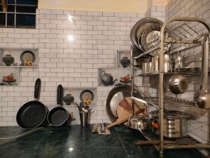 a kitchen with a bunch of pots and pans at Manu home stay in Almora